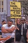 Woman_holding_Equal_Rights_Amendment_sign_in_Los_Angeles,_California,_with_two_men,_one_of_them_yawning